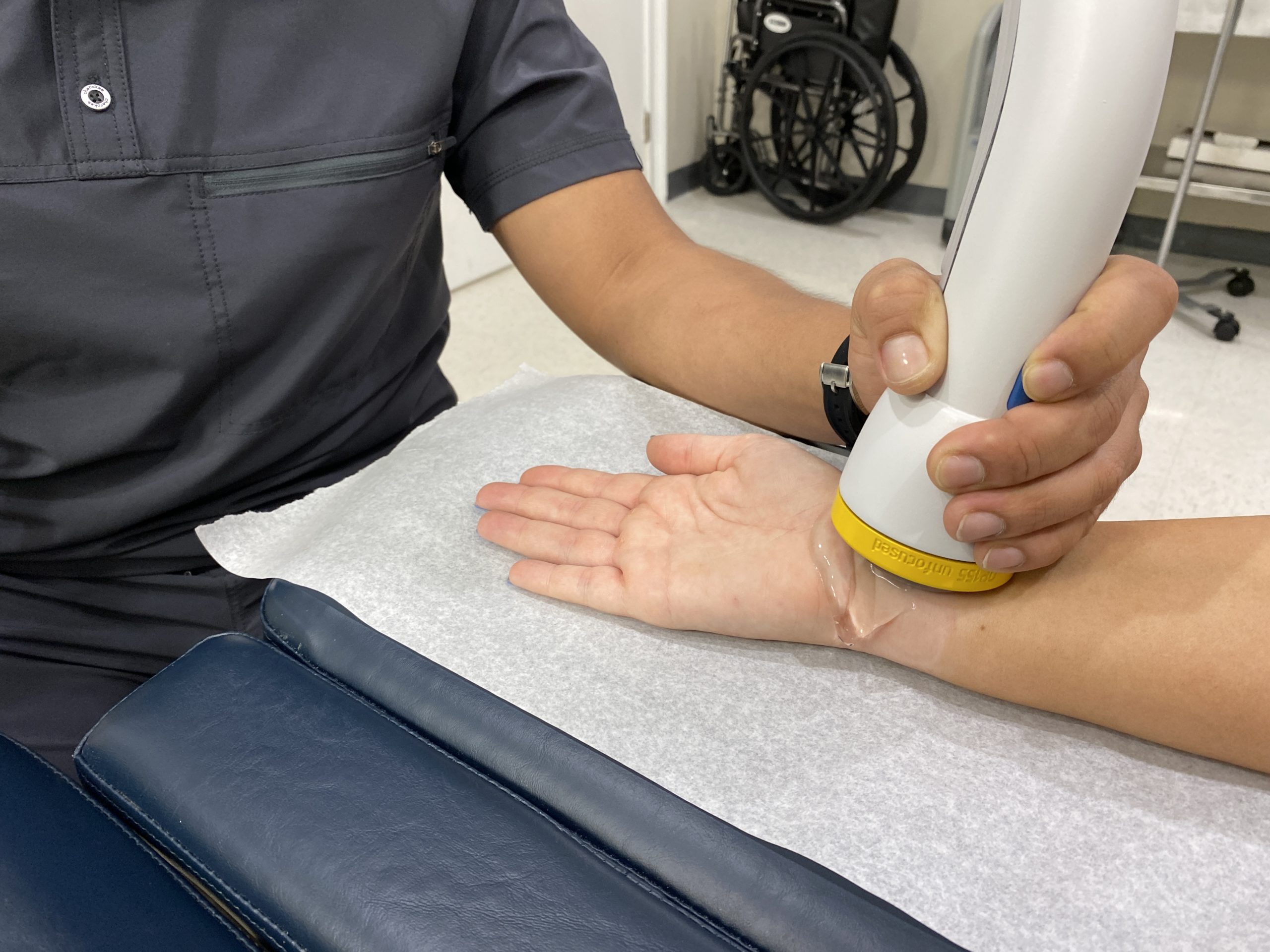 Doctor using Softwave therapy on a patient